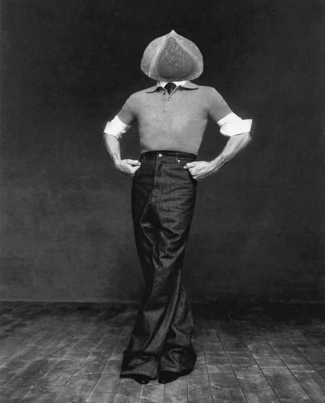 willem dafoe posing hands on hips crossed legs